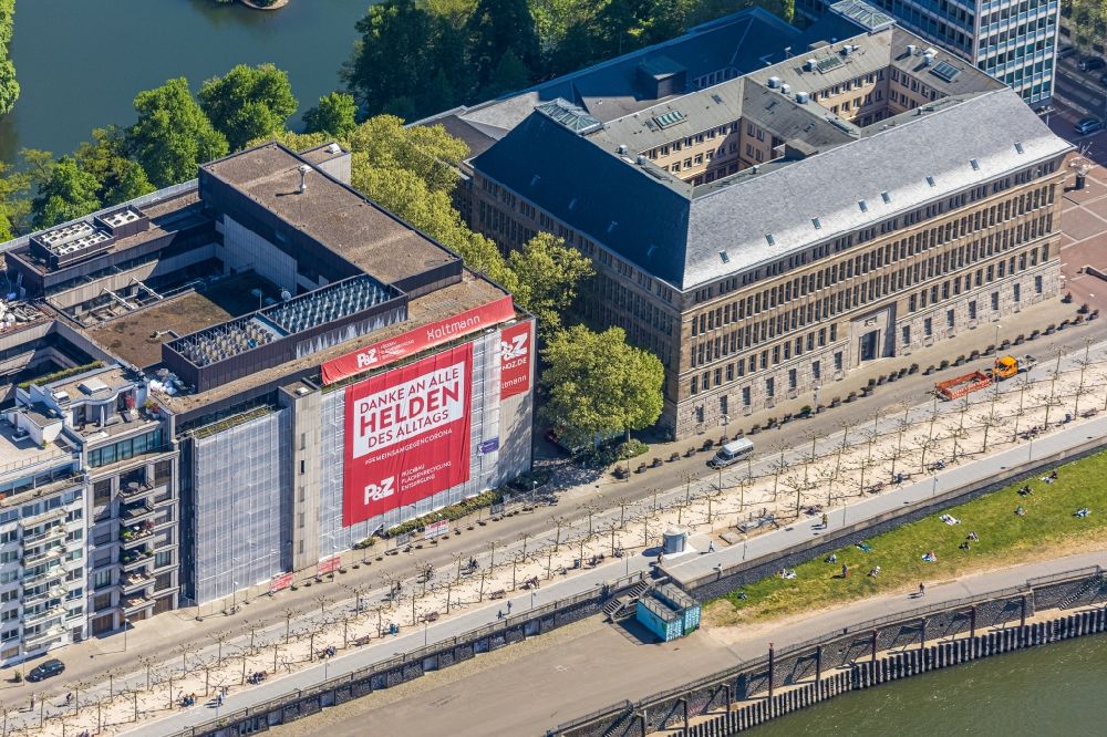 Düsseldorf from the bird's eye view: Office building on Mannesmannufer on shore of rhine overlooking the neighboring building with advertising about Corona in the district Carlstadt in Duesseldorf in the state North Rhine-Westphalia, Germany