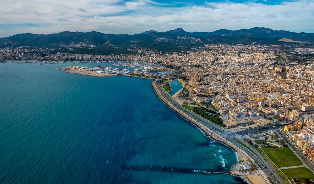Aerial image Palma - Water surface at the bay along the marine coast of the Balearic Sea with a view of the city and port in the Llevant de Palma District in Palma in Balearic Island Mallorca, Spain