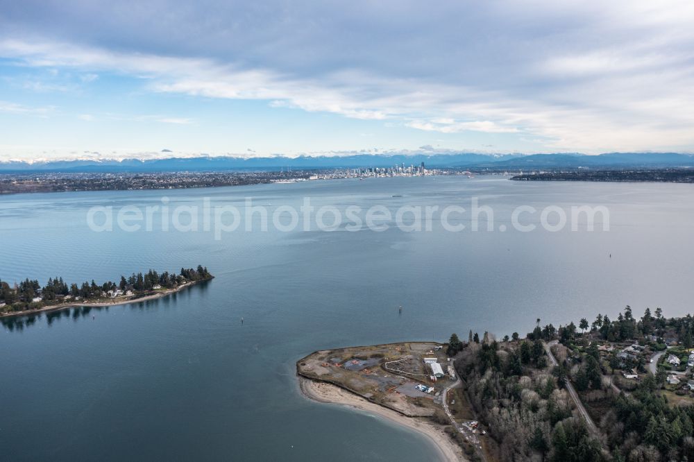 Aerial image Bainbridge Island - Water surface at the bay along the sea coast Elliott Bay in Bainbridge Island in Washington, Seattle Downtown in Background, United States of America