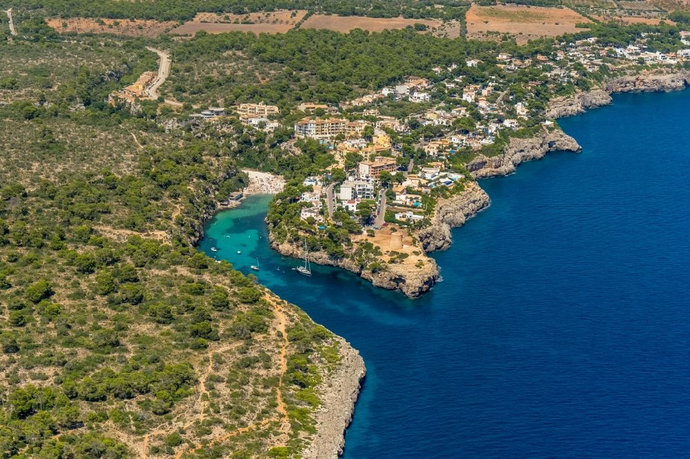Aerial photograph Cala Pi - Water surface at the bay along the sea coast Torre de Cala Pi in Cala Pi in Balearische Insel Mallorca, Spain