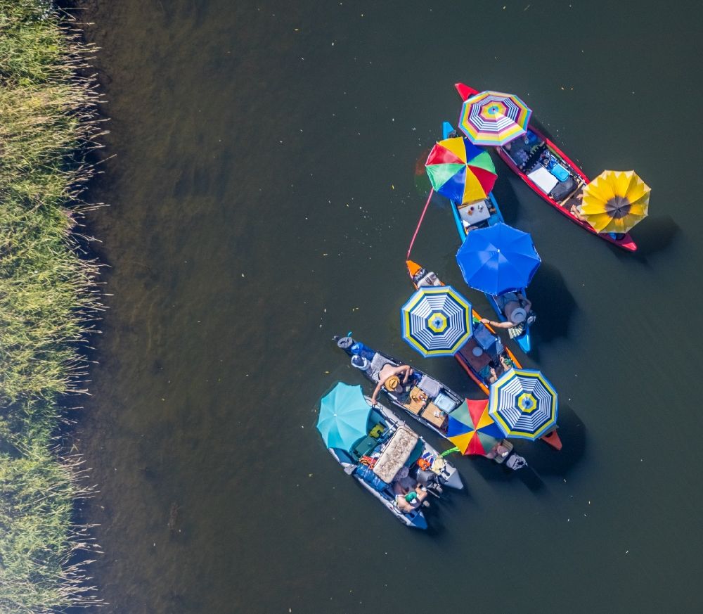 Dorsten from above - Colorful picnic under parasols in boats on the water wall on the Lippe in the district of Hervest in Dorsten in the state North Rhine-Westphalia, Germany