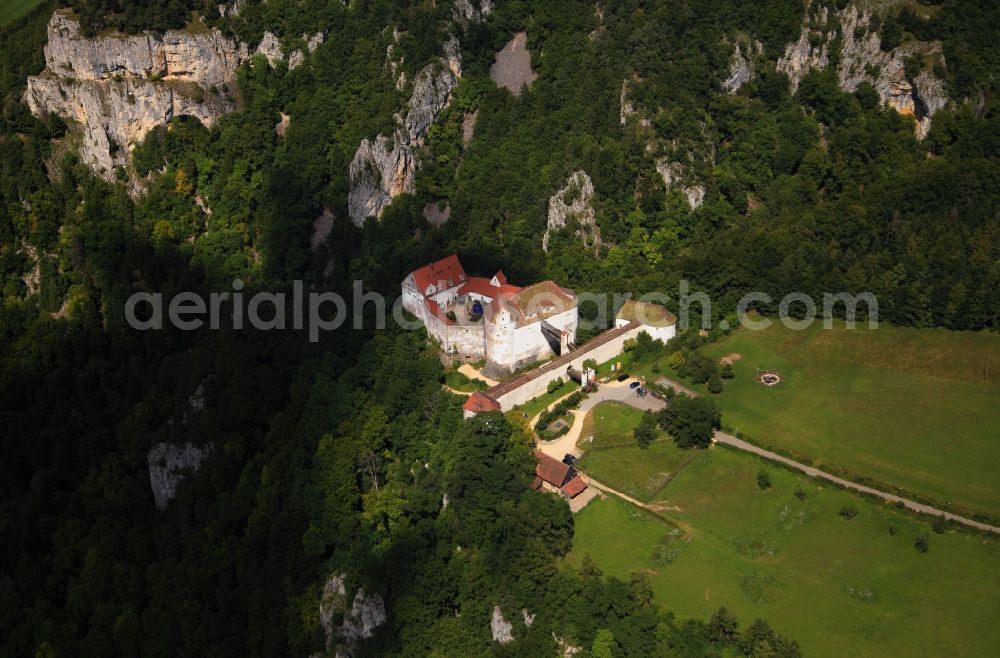 Aerial photograph Leibertingen - Castle Wildenstein in the borough of Leibertingen in the state of Baden-Wuerttemberg. The compound is surrounded by mountains and rocks in a valley in the Swabian Alps. The outbuildings have been in existence unchanged since the 16th century. The complex consists of a stronghold, a main building, a chapel and a moat. Today, it is home to a youth hostel