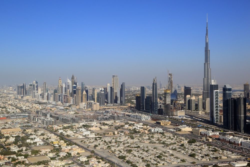 Aerial photograph Dubai - Burj Khalifa is uprising landmark and symbol for the explosively growing city of Dubai in the United Arab Emirates. Countless swanky skyscrapers are under construction and will change the cityscape and skyline to the EXPO 2020