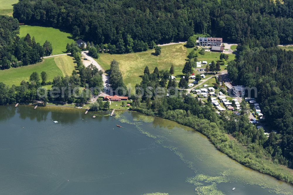 Ibm from the bird's eye view: Campsite with caravans and tents on the lake shore Heratinger See on street Ibm in Ibm in Oberoesterreich, Austria