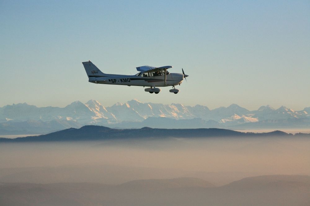 Aerial photograph Rheinfelden (Baden) - Light aircraft Cessna 172 call sign SP-KMO over the landscape of the Upper Rhine Region at Rheinfelden ( Baden ) in the state of Baden-Wuerttemberg. Blue sky and best panoramic view over the mountains of the Swiss Jura to the Swiss Alps
