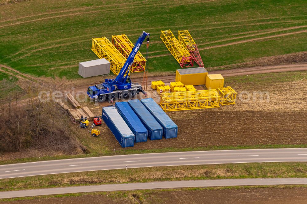 Aerial photograph Ettenheim - Storage area for containers and construction crane segments on a field edge in the industrial park in Ettenheim in the state Baden-Wuerttemberg, Germany