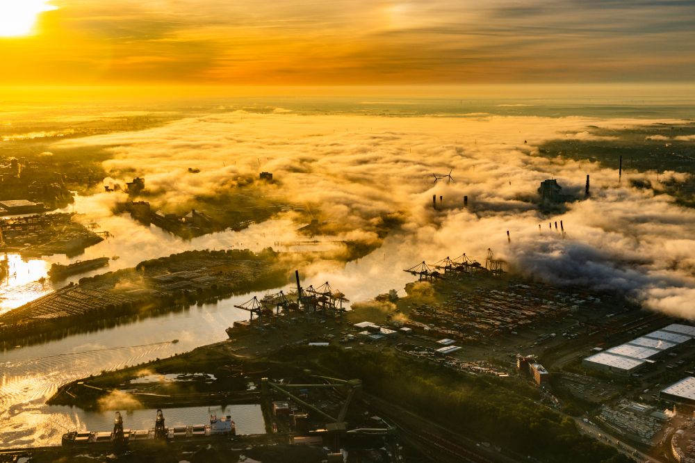 Hamburg from the bird's eye view: Container terminal HHLA Container Terminal Altenwerder (CTA) in the fog at sunrise on the banks of the Elbe in the Altenwerder district in Hamburg