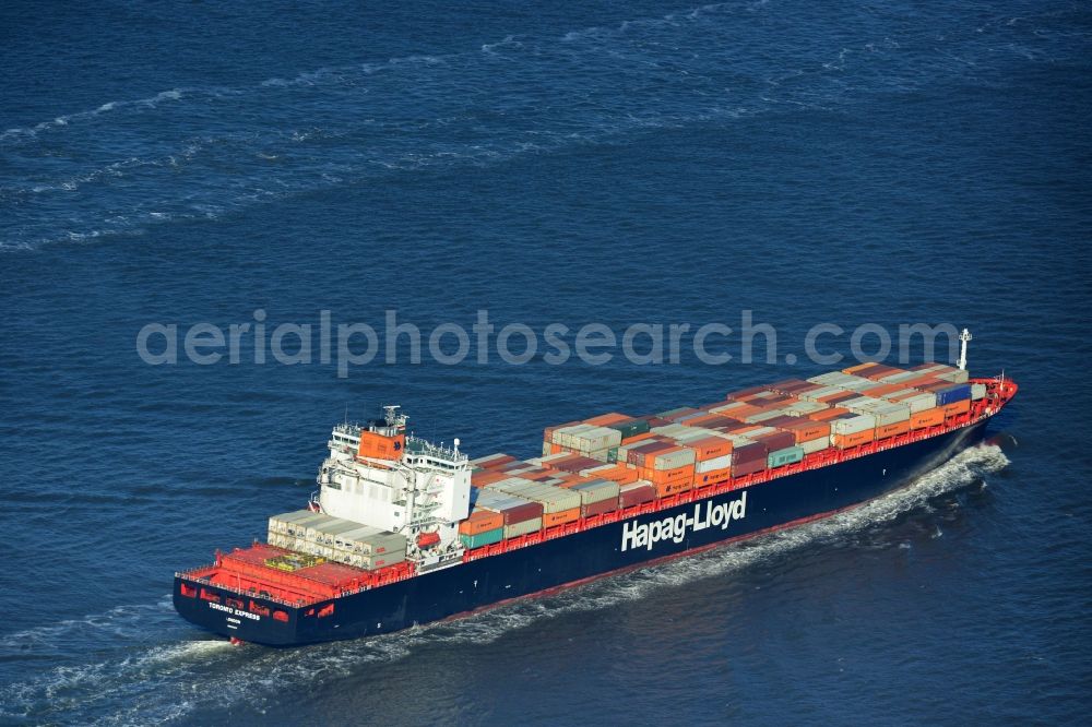 Aerial image Cuxhaven - Container Ship - Freighter TORONTO EXPRESS London shipping company Hapag-LLOYD at driving off the North Sea coast near Cuxhaven in Lower Saxony