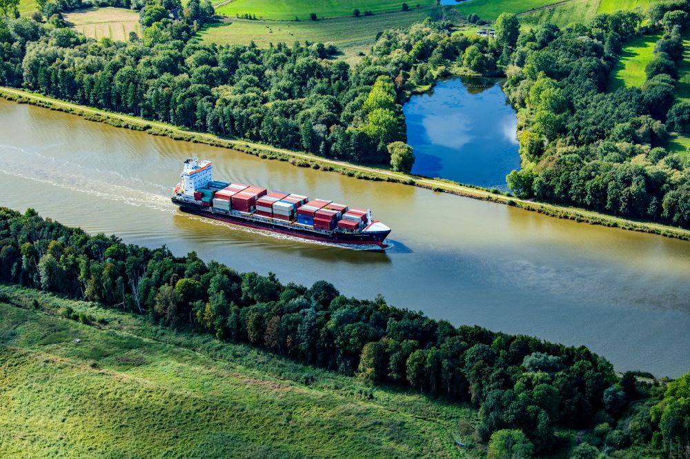 Burg (Dithmarschen) from the bird's eye view: Container ship Nordic Istria on the Kiel Canal in Burg Dithmarschen in the state Schleswig-Holstein, Germany
