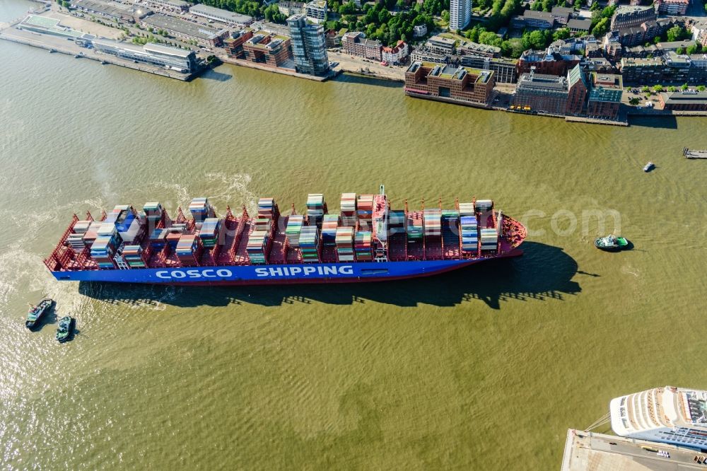 Aerial image Hamburg - Container ship with tugboats in the port in Hamburg, Germany