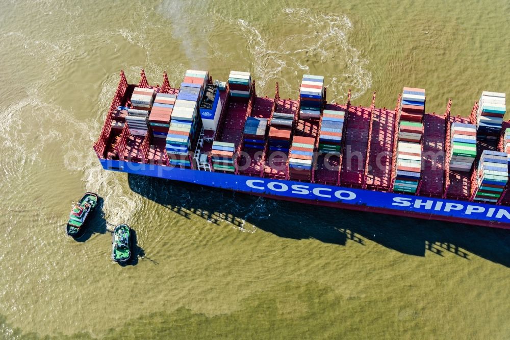 Aerial photograph Hamburg - Container ship with tugboats in the port in Hamburg, Germany