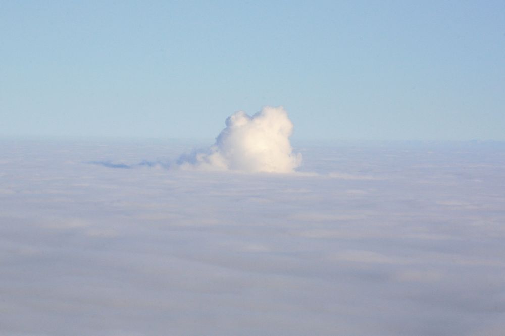 Aerial photograph Leibstadt - Over the Leibstadt Nuclear Power Plant in Switzerland is sticking out of the sea of fog a column of steam from the cooling tower of the nuclear reactor