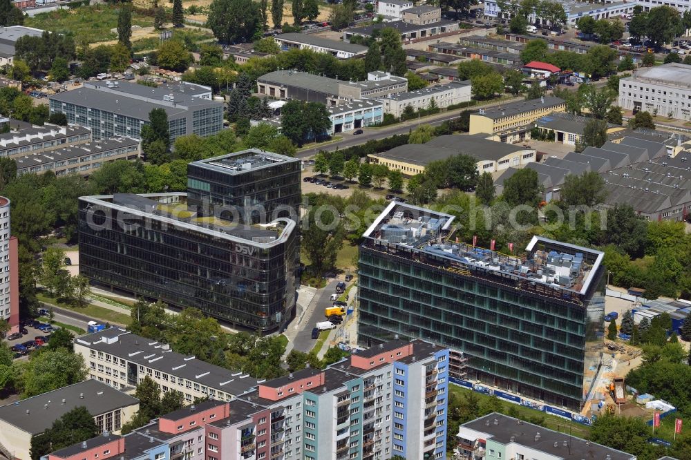 Aerial photograph Warschau - Ambassador Office Building and Ocean Business Park in the Mokotow District in Warsaw in Poland. The two buildings with a glas facade are newly built office and business buildings on Domaniewska Street. Ambassador Office Building is especially elaborate with its square high rise middle part and the round sides. Further to the East, Ocean Business Park is being completed. Its main tenant will be Nestle after its completion