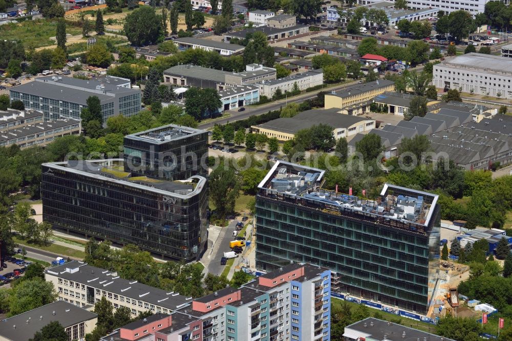 Warschau from above - Ambassador Office Building and Ocean Business Park in the Mokotow District in Warsaw in Poland. The two buildings with a glas facade are newly built office and business buildings on Domaniewska Street. Ambassador Office Building is especially elaborate with its square high rise middle part and the round sides. Further to the East, Ocean Business Park is being completed. Its main tenant will be Nestle after its completion