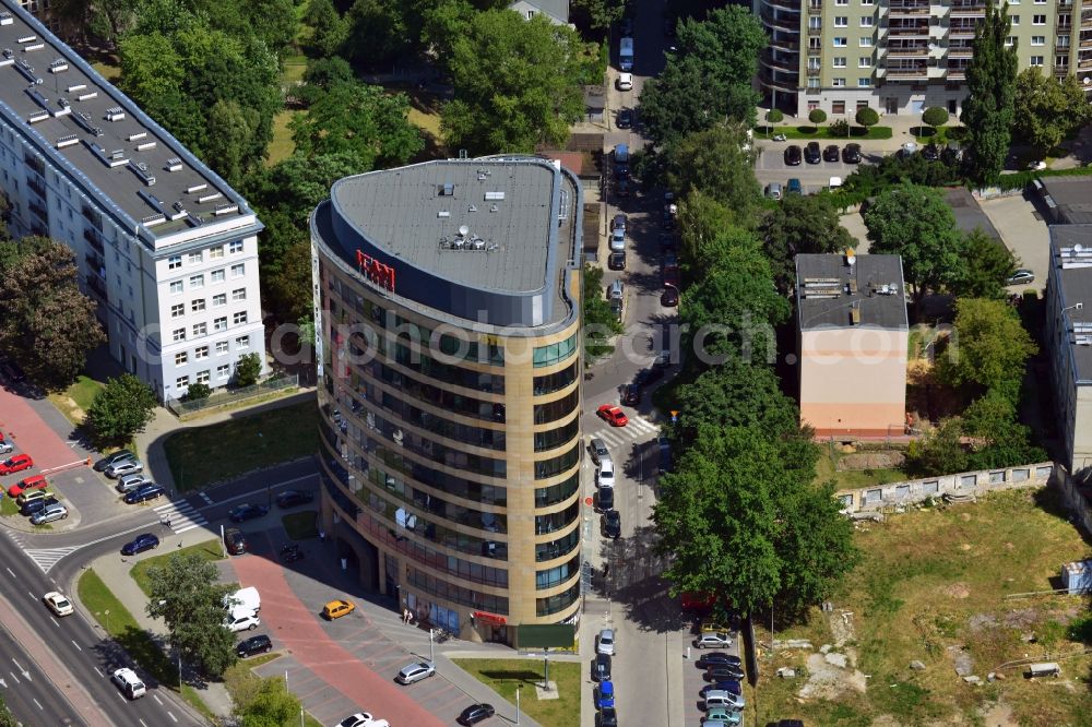 Warschau from above - The office building of ICAN Institute in the Ksawerow part of the district of Mokotow in Warsaw in Poland. Inside the building there are several coworking spaces, restaurants and shopping facilities. The distinct building with the round and curvy shapes is located on a street corner surrounded by a parking lot