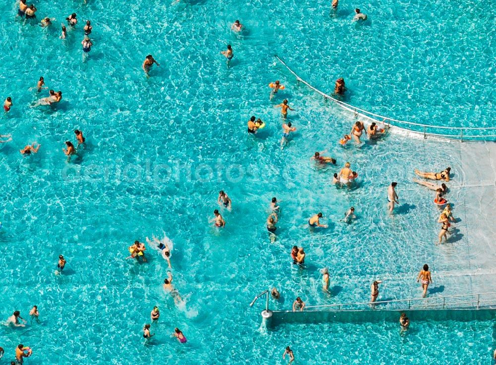 Tübingen from above - The swimming pool in Tübingen in the state of Baden-Württemberg. The outdoor facilities consist of a sport pool, a threefold children's pool and a water slide. Swimmers and visitors also make use of the extensive green areas to sunbathe