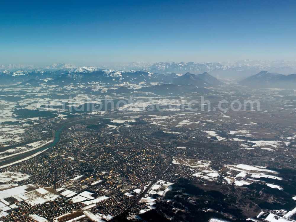 Rosenheim from above - The snowed in and frozen city of Rosenheim in the free state of Bavaria. Overview and landscape of the city and its surrounding environment. Visible in the background are mountains and peaks of the alps. Rosenheim is the thirdlargest city in the region of Oberbayern and is located on the shores of the river Inn