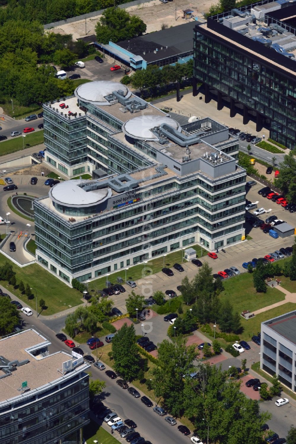 Warschau from the bird's eye view: The headquarters of Ringier Axel Springer Media AG in the Mokotow district of Warsaw in Poland. The joint venture of the German and Swiss publishing houses has been created in 2010 and is located in the rectangular building in the Southwest of the district. The facility is surrounded by other office low rise buildings in the Sluzewiec part of the district