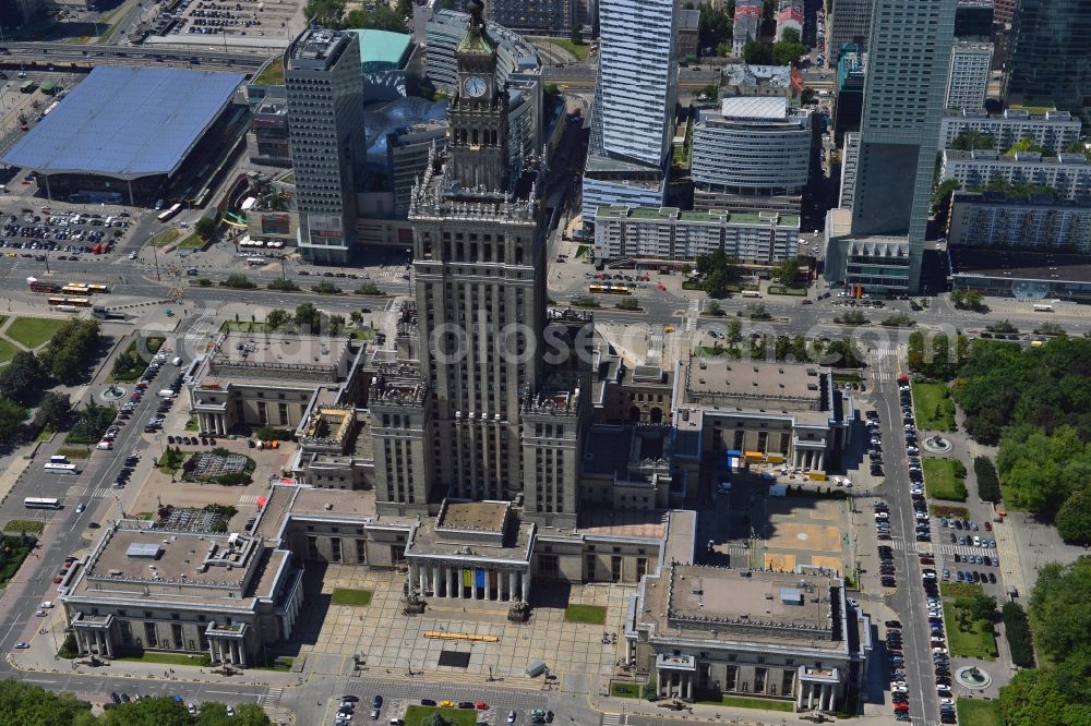 Warschau from the bird's eye view: The high-rise building complex of the Palace of Culture and Science (Palac Kultury i Nauki Polish) in downtown Warsaw in Poland. The building and landmark of the city was a gift by the former Soviet Union. It was designed by the architect Lew Rudnew in a socialist classicist style. It is the highest building in Poland and is surrounded by new high rise buildings and towers. Its top is used as an antenna and broadcasting tower for radio, TV and several mobile network operators