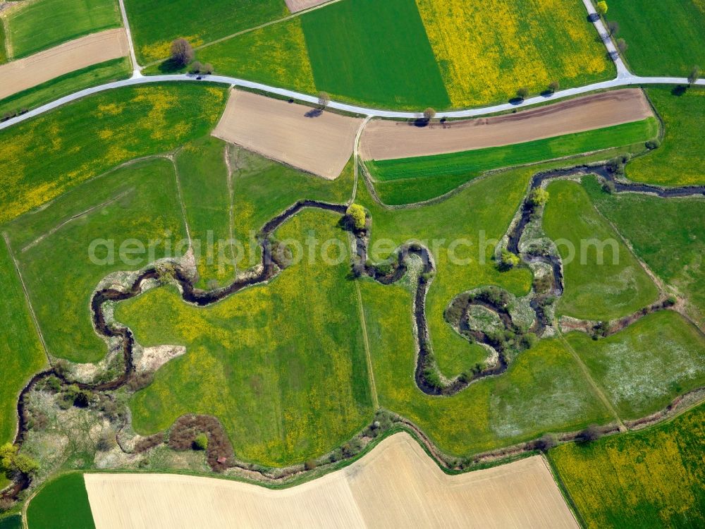 Aerial image Aletshausen - The mean der of the Kammel river in the county of Aletshausen in the state of Bavaria. The county is located in the Swabian county district of Günzburg. The river runs parallel to the federal highway B16. Typical for a mean der, the river runs through fields and greens