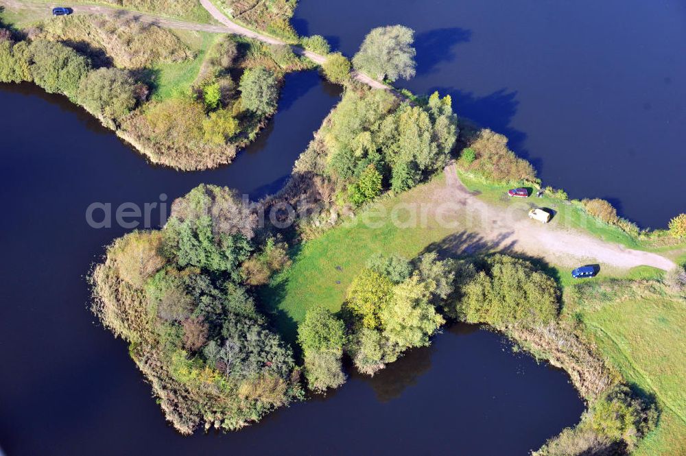 Oberkrämer from above - View of the Mühlen lake in the local district Vehlefanz of the municipality Oberkrämer in Brandenburg. The lake was created by the LPG to be used as a water reservoir to irrigate the surrounding fields. To this day, the lake is still used for that