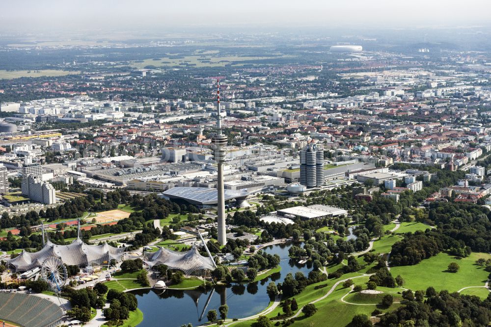 Aerial image München - The Olympic Park in Munich in the state of Bavaria. In the foreground lies the Olympic Stadium that is today used for cultural events and concerts. Behind it, the TV tower, the Olympic Tower, one of the landmarks of the city is visible. The large park and lake form one of the largest open spaces in Munich