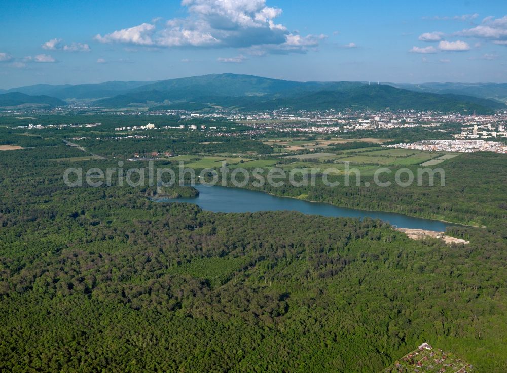 Aerial image Freiburg - The lake Opfinger See in the Mooswald district of the city of Freiburg in the state of Baden-Württemberg. Mooswald is located in the West of the city in the Breisgau area. Next to the lake there is another smaller pond surrounded by forest. In the background lies the center of Freiburg