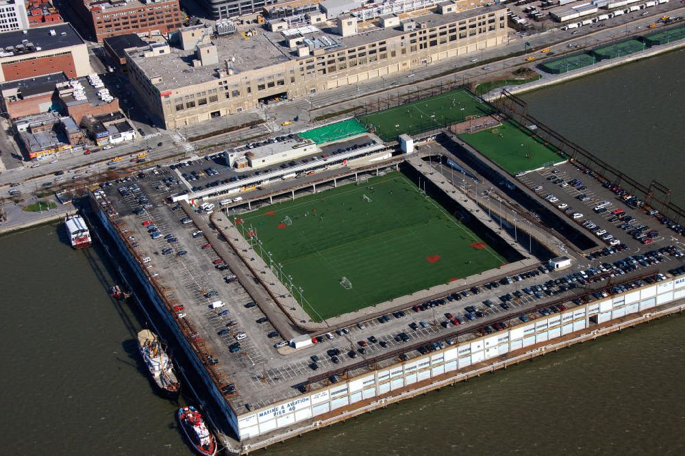 New York from above - View of the Hudson River Park Pier 40. It was built in 1963 and until 1973, it was used by the Holland America shipping company. Today it provides space for athletes in football, american football, rugby and baseball. He is also a dock for cruise ships, historic ships and kayak rental. The rugby and football team New York Knights play their home games on this ground
