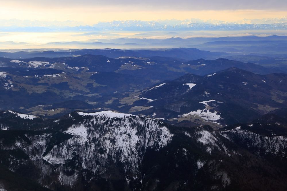 Aerial photograph Aitern - The snow covered mountain Belchen in the Black Forest in Aitern in the state Baden-Wuerttemberg. Looking southbound to the swiss Alps