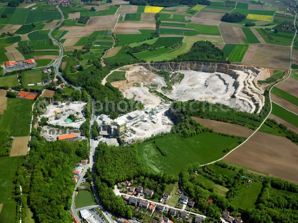 Gräfenberg from the bird's eye view: The quarry and stone pit at Mountain Gräfenberg in the Spessart area of the state of Bavaria. The mountain is a sandstone outlier that is surrounded by lime. The lime is being mined today, the sandstone was mined until World War II
