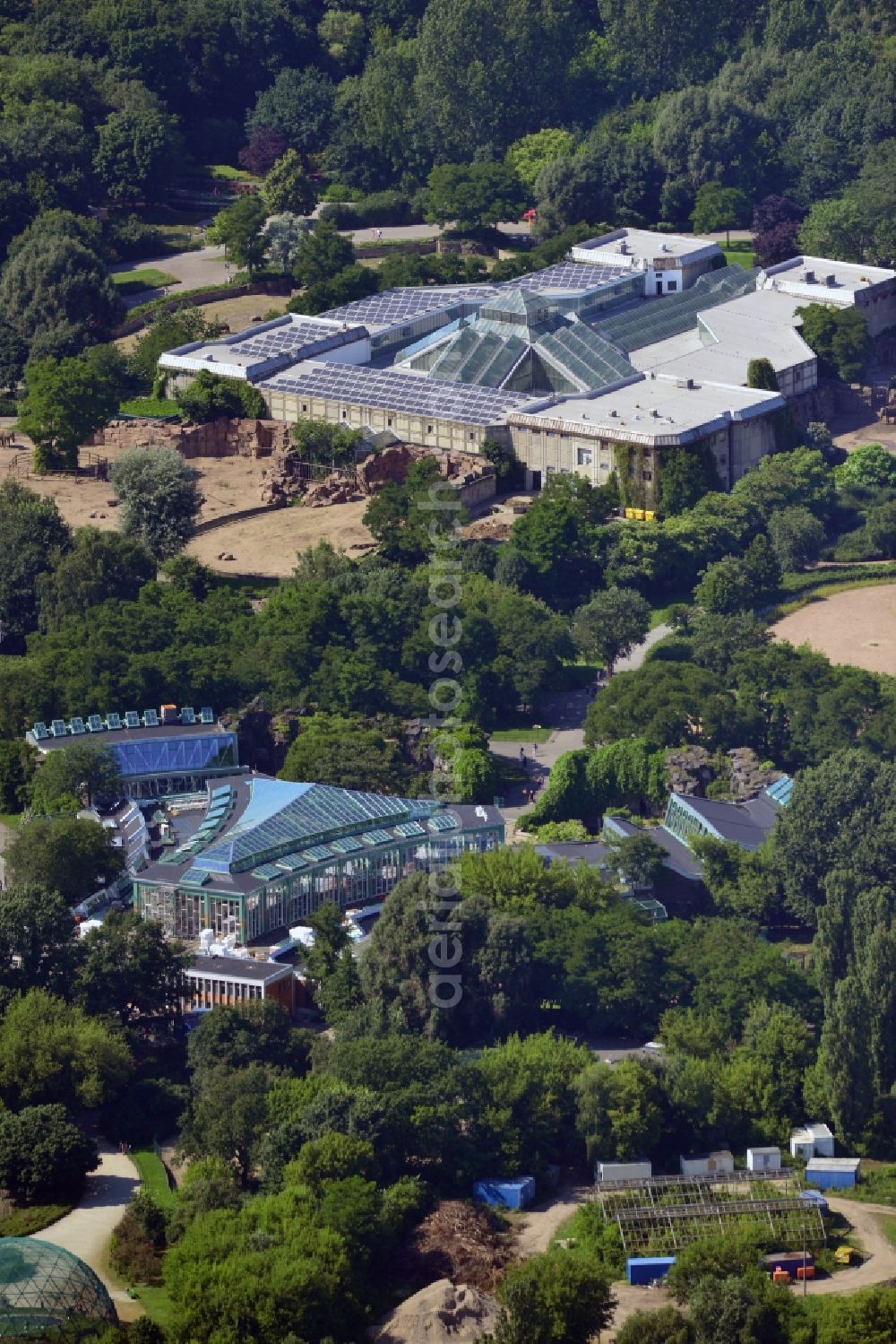 Aerial image Berlin - The zoo Tierpark Berlin in the Friedrichsfelde part of the district of Lichtenberg in Berlin in the state of Brandenburg. The park is the biggest landscape zoological garden in Europe. View of the Alfred Brehm House in the foreground which includes a café and is a listed building. In the background is the big pachyderm building - the Elephant House - which is home to African and Asian elephants