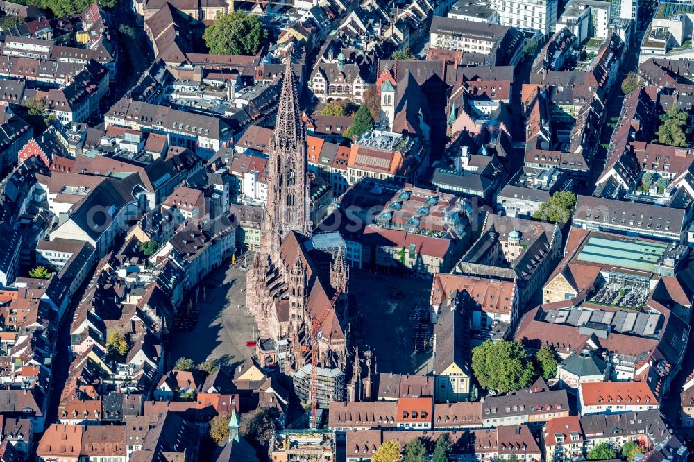 Freiburg im Breisgau from above - Church building Freiburger Muenster in the Old Town- center of downtown Freiburg im Breisgau in the state Baden-Wurttemberg, Germany. The steeple, after years of renovation, can now be seen without scaffold