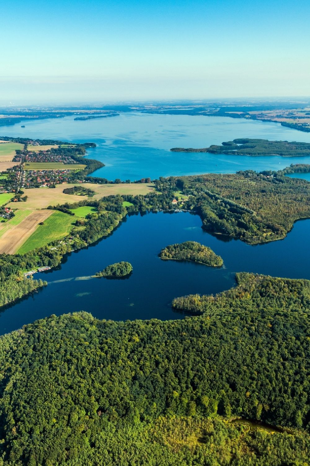 Aerial image Schwerin - The lake Ziegelsee in the urban area of Schwerin in the state of Mecklenburg-Vorpommern. The lake is part of the EU bird protection area Schweriner Seen and is partly listed as a nature park and protected area. It is used for boating, shipping and watersports. Next to it is the bigger Schweriner Aussensee (Outer Lake)