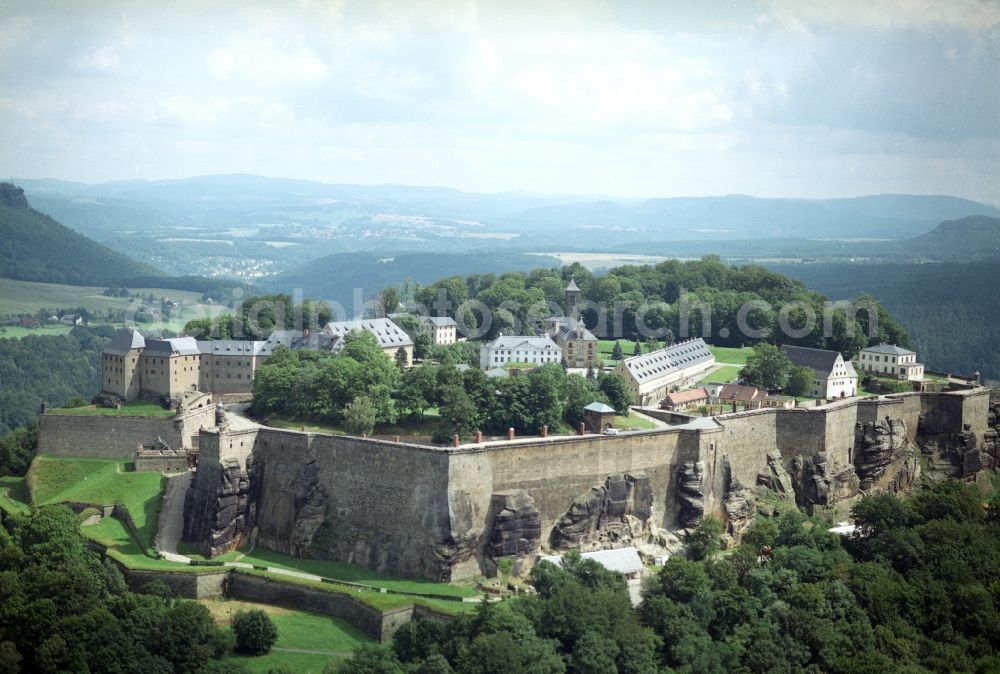 Königstein from above - The Fortress Koenigstein at the river Elbe in the county district of Saxon Switzerland East Erzgebirge in the state of Saxony. The fortress is one of the largest mountain fortresses in Europe and is located amidst the Elbe sand stone mountains on the flat top mountain of the same name. In front of it, the river runs through a valley