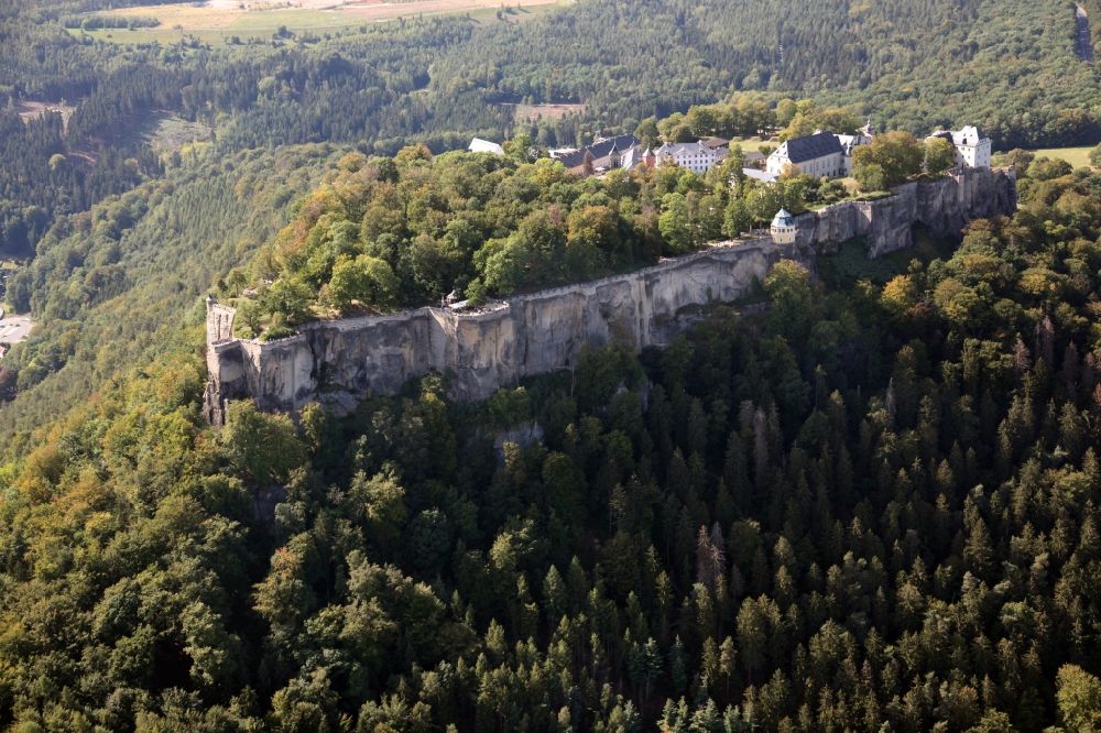 Königstein from the bird's eye view: The Fortress Koenigstein at the river Elbe in the county district of Saxon Switzerland East Erzgebirge in the state of Saxony. The fortress is one of the largest mountain fortresses in Europe and is located amidst the Elbe sand stone mountains on the flat top mountain of the same name