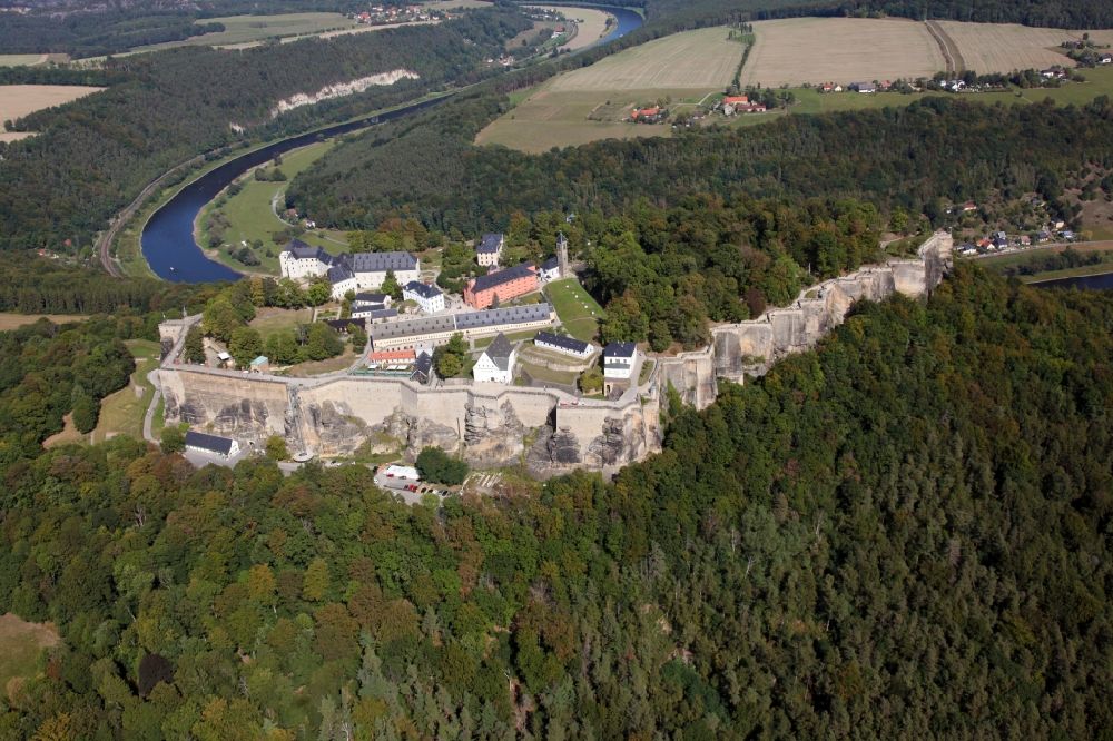 Aerial photograph Königstein - The Fortress Koenigstein at the river Elbe in the county district of Saxon Switzerland East Erzgebirge in the state of Saxony. The fortress is one of the largest mountain fortresses in Europe and is located amidst the Elbe sand stone mountains on the flat top mountain of the same name