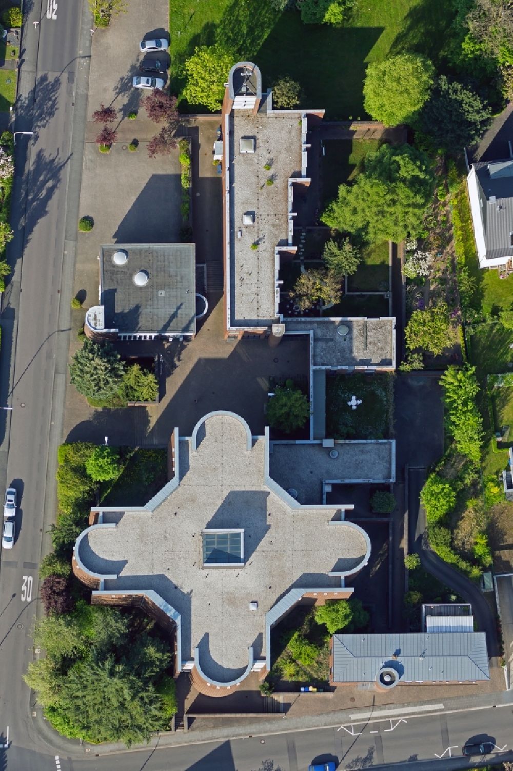 Aerial photograph Bonn - The Heilig-Kreuz Church (Holy Cross) in the Limperich part of the district of Beuel in Bonn in the state of North Rhine-Westphalia. Church and adjacent monastery were built in the shape of a cross in the 1960s