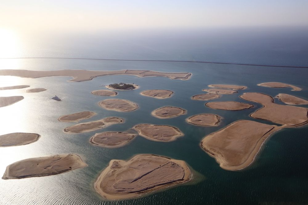 Dubai from the bird's eye view: The islands of The World just off the coast of Dubai in the United Arab Emirates consists of about three hundred man-made islands. The giant project threatens to become a flop. Since 2011, the construction works rest. Only two islands are completed and inhabited
