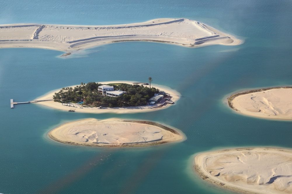 Aerial photograph Dubai - The islands of The World just off the coast of Dubai in the United Arab Emirates consists of about three hundred man-made islands. The giant project threatens to become a flop. Since 2011, the construction works rest. Only two islands are completed and inhabited
