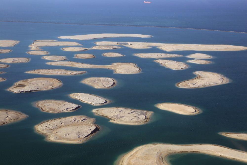 Dubai from above - The islands of The World just off the coast of Dubai in the United Arab Emirates consists of about three hundred man-made islands. The giant project threatens to become a flop. Since 2011, the construction works rest. Only two islands are completed and inhabited