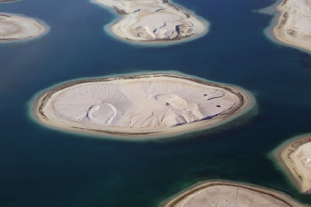Dubai from the bird's eye view: The islands of The World just off the coast of Dubai in the United Arab Emirates consists of about three hundred man-made islands. The giant project threatens to become a flop. Since 2011, the construction works rest. Only two islands are completed and inhabited