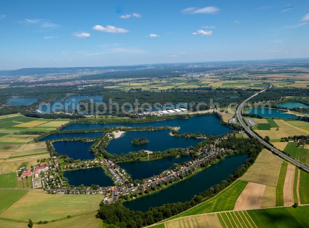 Otterstadt from the bird's eye view: The landscape and lakes in the village of Otterstadt in the state of Rhineland-Palatinate. The village is characterised by lakes and small ponds and various small island which form the recreational area. Shipping, swimming and hiking are typical tourism offerings. The village belongs to the community of Waldsee and is located on the Autobahn A61 and the river Rhine