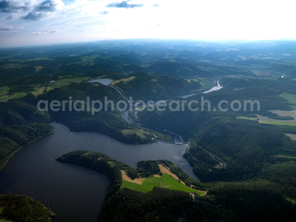 Hohenwarte from above - The landscape around and the barrier lake Hohenwarte in the state of Thuringia. The barrier lake was created through the barricade and damming the river Saale in the county of Hohenwarte. It is used for flood protection and for energy through the pumped storage hydro power station Hohenwarte I. It is the fourth largest valley dam and barrier lake in Germany