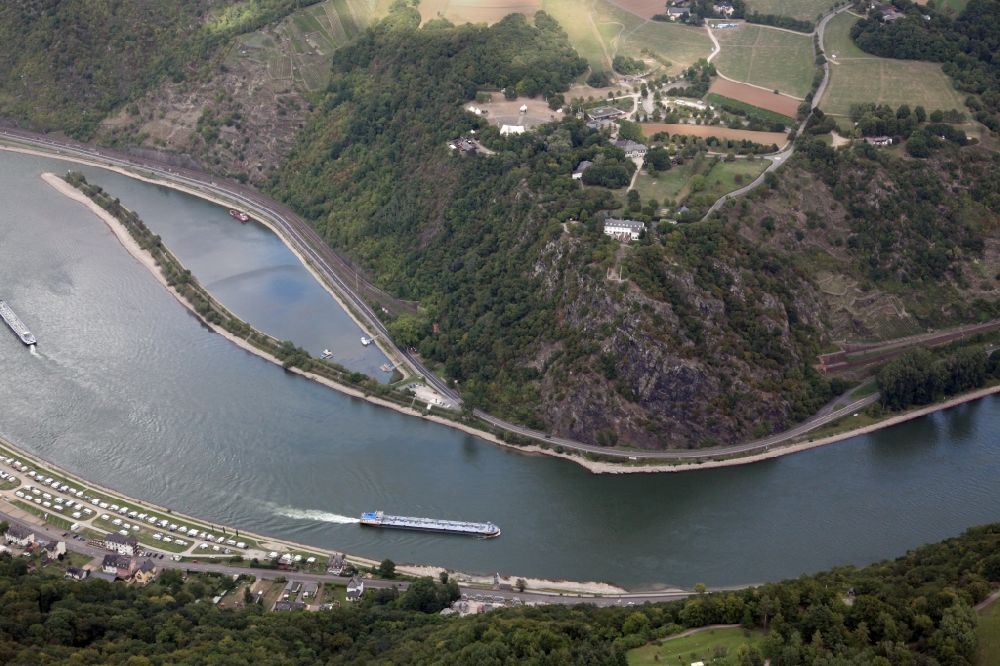 Aerial image Kaub - The Loreley near Sankt Goarshausen in the state of Rhineland-Palatinate. The Loreley is a slate rock in the UNESCO World Heritage Upper Middle Rhine Valley, located on the inside of a bend in the Rhine in the eastern, right bank of the Rhine. On the plateau is the open air stage Loreley, hwo regularly hosts major events (eg, rock concerts). Loreley is also the name of a mermaid on this rock. According to legend, she combed her there long golden hair and attracted the sailors with their singing. They did no longer stay attentively despite dangerous flow on the course, so that the ships were wrecked at the cliffs. For tourism, the Loreley is the epitome of the Romantic Rhine