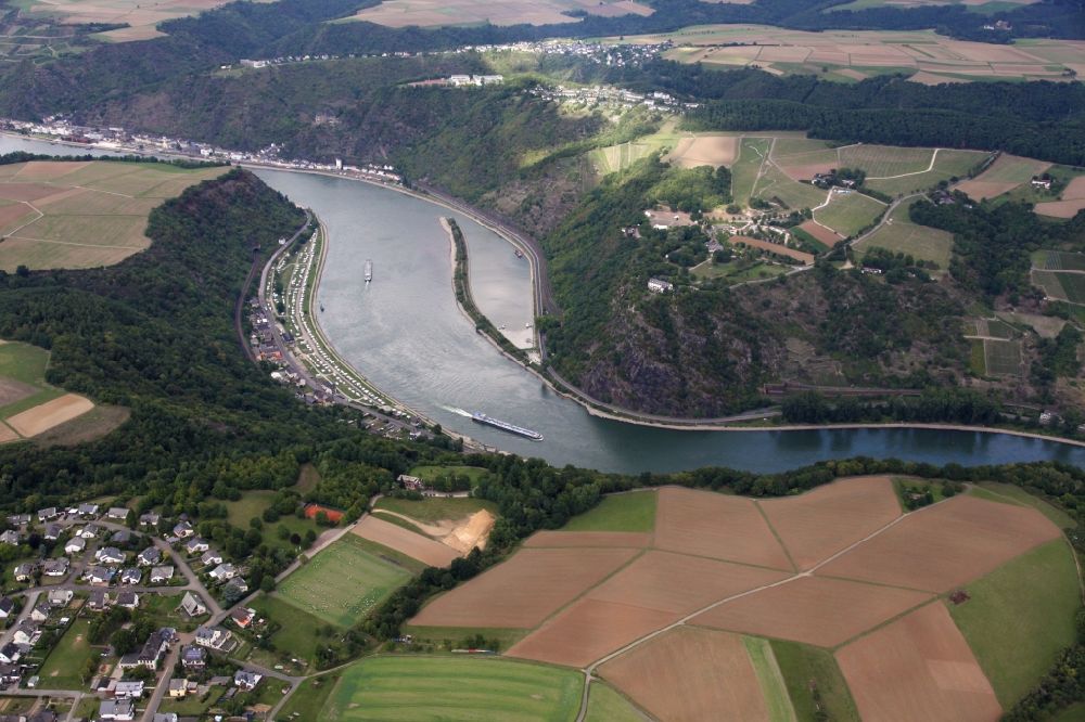 Aerial photograph Kaub - The Loreley near Sankt Goarshausen in the state of Rhineland-Palatinate. The Loreley is a slate rock in the UNESCO World Heritage Upper Middle Rhine Valley, located on the inside of a bend in the Rhine in the eastern, right bank of the Rhine. On the plateau is the open air stage Loreley, hwo regularly hosts major events (eg, rock concerts). Loreley is also the name of a mermaid on this rock. According to legend, she combed her there long golden hair and attracted the sailors with their singing. They did no longer stay attentively despite dangerous flow on the course, so that the ships were wrecked at the cliffs. For tourism, the Loreley is the epitome of the Romantic Rhine