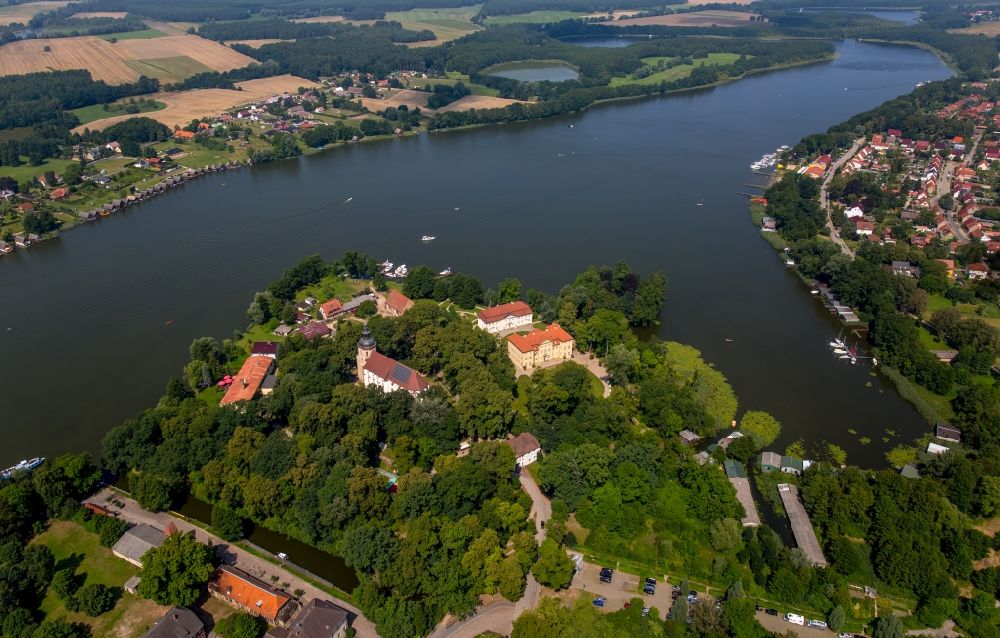 Aerial photograph Mirow - The Mirow Castle island with its ensemble of buildings of the castle Mirow, the cavalier house and the St. John church on Lake Mirow in Mirow in Mecklenburg-Vorpommern