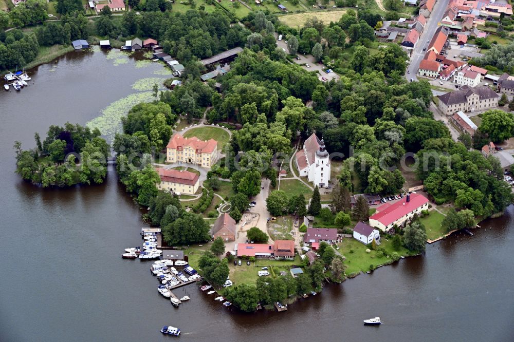 Aerial image Mirow - The Mirow Castle island with its ensemble of buildings of the castle Mirow, the cavalier house and the St. John church on Lake Mirow in Mirow in Mecklenburg-Vorpommern