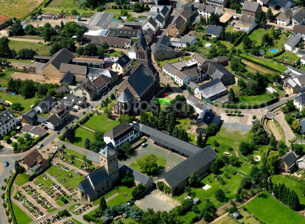 Aerial photograph Wallersheim - The parish church of the village is situated in a residential area on the outskirts of the village. It is enclosed by a small Parkanlsge