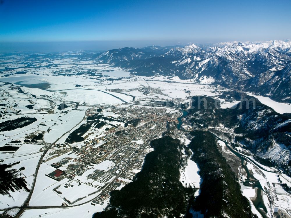 Füssen from above - The snow covered city of Füssen in the Allgäu region of the state of Bavaria. Füssen borders the Alps and the river Lech. Visible in the Winterlandscape are also the fields of the area and the region of Ostallgäu