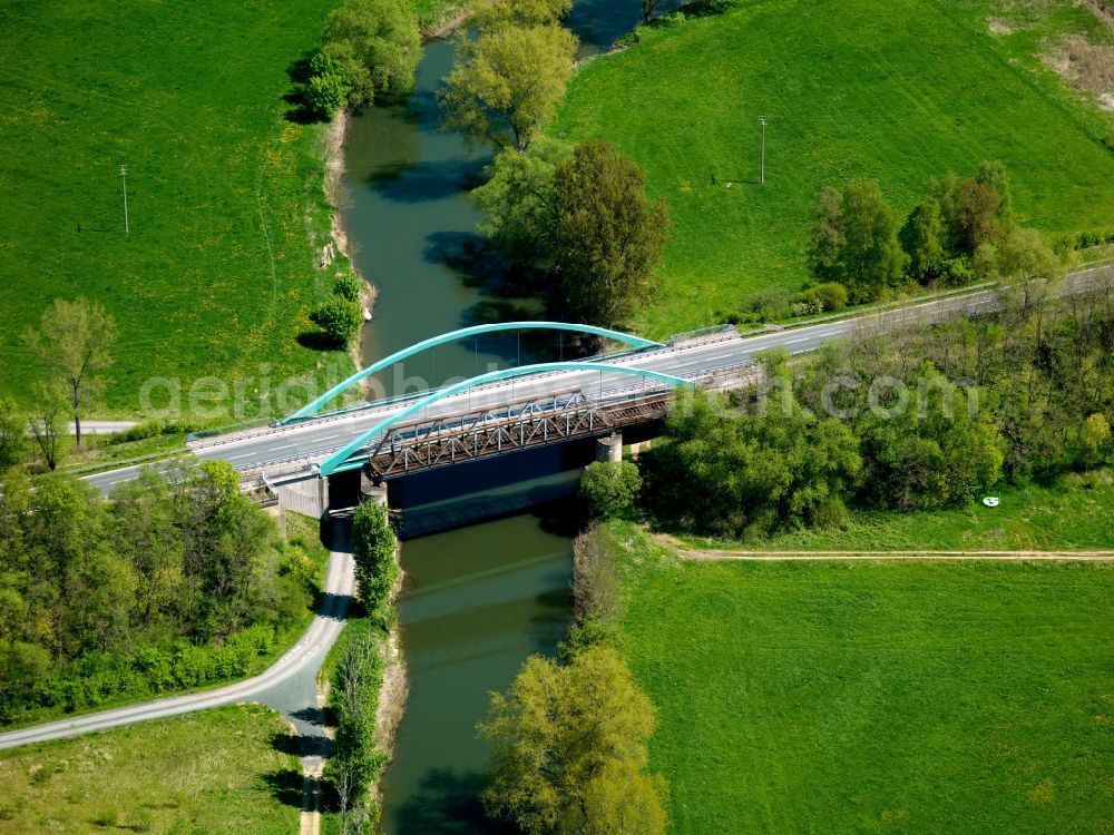 Aerial image Gerstungen - The Werra bridge in Gerstungen in the state of Thuringia. The bridge with its distinct blueish arcs leads over the river Werra from the East into the town of Gerstungen. Next to it are remains of an old railway bridge. The bridge holds the country road L1020